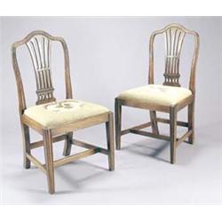 A set of six late George III mahogany dining chairs, each with a serpentine back and pierced spla...