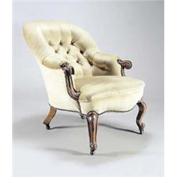 A Victorian walnut armchair, with padded button back, sides and seat, scroll carved arm supports...