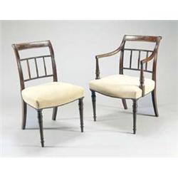 A set of eight George IV mahogany dining chairs, each with a flame veneered backrail and a reeded...