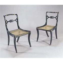 A set of six Regency ebonised side chairs, each with a reeded crest and 'X' back rail with brass...