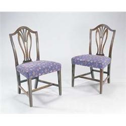 A set of six late George III mahogany dining chairs, each with a serpentine crest and stylised pi...