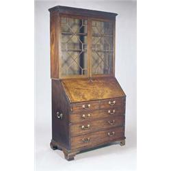 A George III mahogany bureau bookcase, the moulded cornice above two astragal glazed doors enclos...