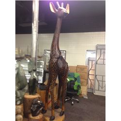 11' TALL GIRAFFE, CARVED FROM A SINGLE PIECE OF AFRICAN MAHOGANY, WEIGHING SEVERAL HUNDRED POUNDS.