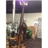 Image 1 : 11' TALL GIRAFFE, CARVED FROM A SINGLE PIECE OF AFRICAN MAHOGANY, WEIGHING SEVERAL HUNDRED POUNDS.