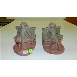 Rookwood bookends w/ young girl on bench w/ a book in mauve / green glaze, 2446 1922, ht. 5 1/2 in.