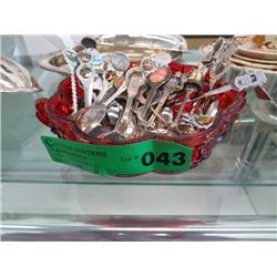 Red glass dish full of collector's spoons