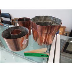 Two copper molds and a copper mug