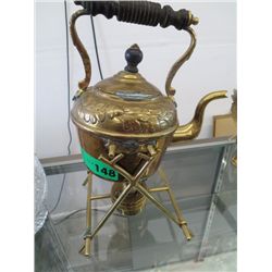 Brass teapot over a heating unit