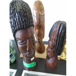 Three carved African heads