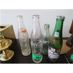 Four collectible glass soda bottles