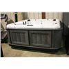Image 1 : 89" X 89" CAL SPAS XTREME SERIES HOT TUB WITH STERLING SILVER INTERIOR AND GREY MIST CABINET.