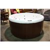 Image 1 : 78" ROUND CAL SPAS COLEMAN SERIES HOT TUB WITH SNOW WHITE INTERIOR AND MAHOGANY CABINET.