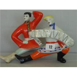 Russian figure of dancing cossacks £20 - 40...