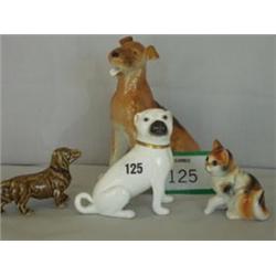 Three ceramic dogs plus a cat £20 - 40...