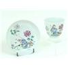 Image 1 : AN 18TH CENTURY FAMILLE ROSE CUP AND SAUCER: decorated a solitary  bird in a fenced garden settin