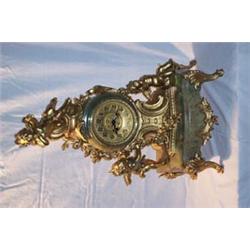 FRENCH ORMOLU AND ONYX MANTEL CLOCK,eight day movement with brass dial, franked and mounted by cl...