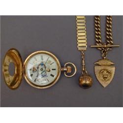 A silver gilt masonic orb opening to reveal bright cut signs, complete with gold fob chain, stamp...