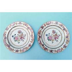 A pair of Chien Lung famille rose dishes, painted with central floral bouquet within gilt floral...