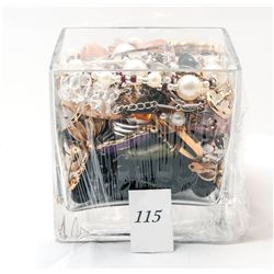 Glass jar filled with costume jewelry