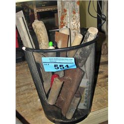 Black metal basket filled with trowels