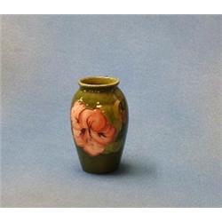 A Moorcroft coral hibiscus pattern on a green ground baluster shaped vase 4  (1968-1980)  (ILLUST...