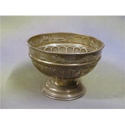 A circular embossed silver bowl raised on a socle base Birmingham 1914 9  ILLUSTRATED  £75-125...