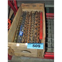 Wooden crate filled with long wood drill bits