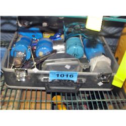 Suitcase filled with assorted camping gear;