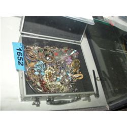 Metal case filled with assorted costume jewelry