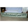 Image 1 : 1 SIGN "WESTERMANS GROCERY" ON WOOD IN GOOD COND. H24", L144". WT. 50LBS....