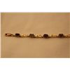 Image 1 : STAMPED 10K YELLOW GOLD ALEXANDRITE BRACELET. CENTER WEIGHT: 3.30 CARAT. WEIGHT: 4.10 GRAMS. CENTER