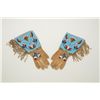 Image 2 : Fancy men’s gauntlets showing fringed buckskin with beaded floral cuffs and accents on top of hand a