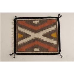 Small Navajo sampler rug from Gallup area measures approximately 17” x 14” showing tight weave in go