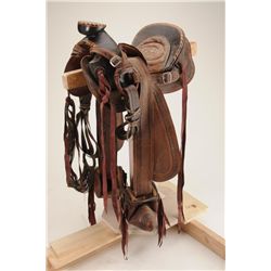 Mexican saddle with inlaid wood horn and cantle, tooled leather skirts, padded leather seat, wood st