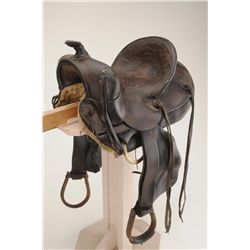 Fred Mueller-marked leather bronc saddle; metal trimmed wood stirrups, well-used fair to good condit