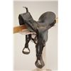 Image 1 : Child’s leather saddle with wooden stirrups in overall fair to good condition showing lots of even w