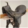 Image 2 : Child’s leather saddle with wooden stirrups in overall fair to good condition showing lots of even w