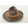 Image 1 : Unmarked brown felt cowboy hat with wide sweat band in overall good condition and the type a cowboy 