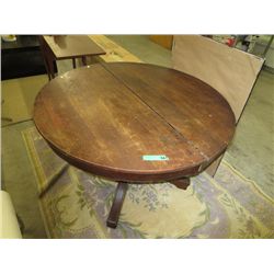 Wood pedestal table on casters