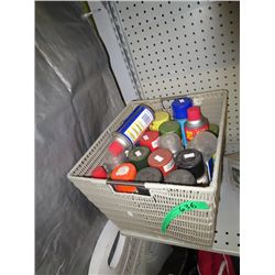 Plastic basket full of paints and WD-40