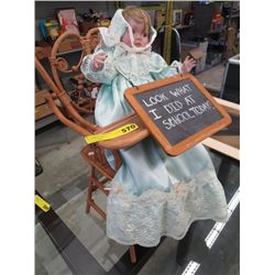 Doll in wooden high chair