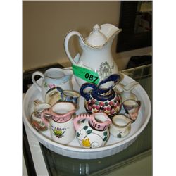 Dish containing ten collectible mini jugs