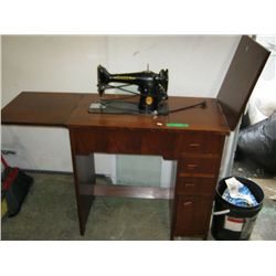 Vintage Singer sewing machine in cabinet