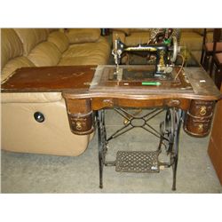 Antique treadle sewing machine in cabinet