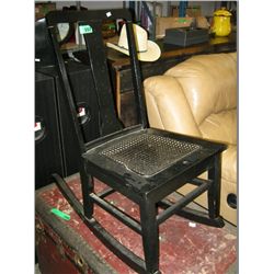 Black wooden rocking chair with rattan seat