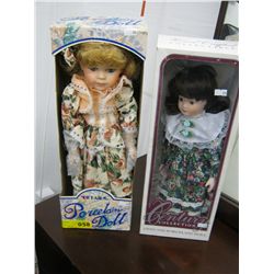 Two porcelain dolls, new in boxes
