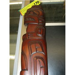 Carved native plaque of a bear