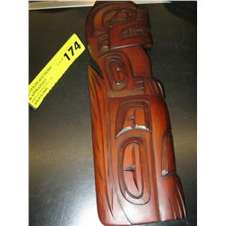 Carved native plaque of a wolf