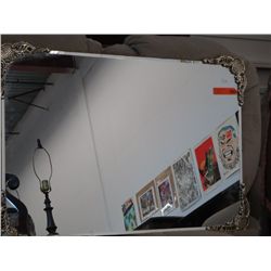 Bevel edged mirror with metal corner decoration