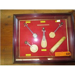 Box framed display of Oriental instruments